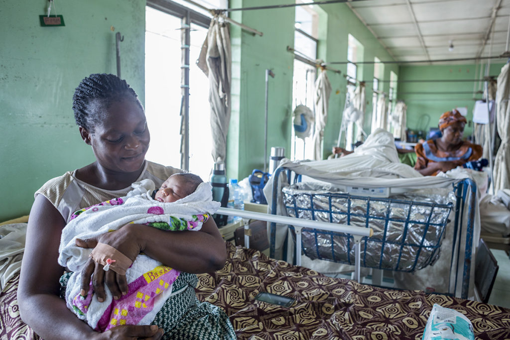 A mother cuddles her new born as she prepares to leave the antenatal ward, UCH, Ibadan